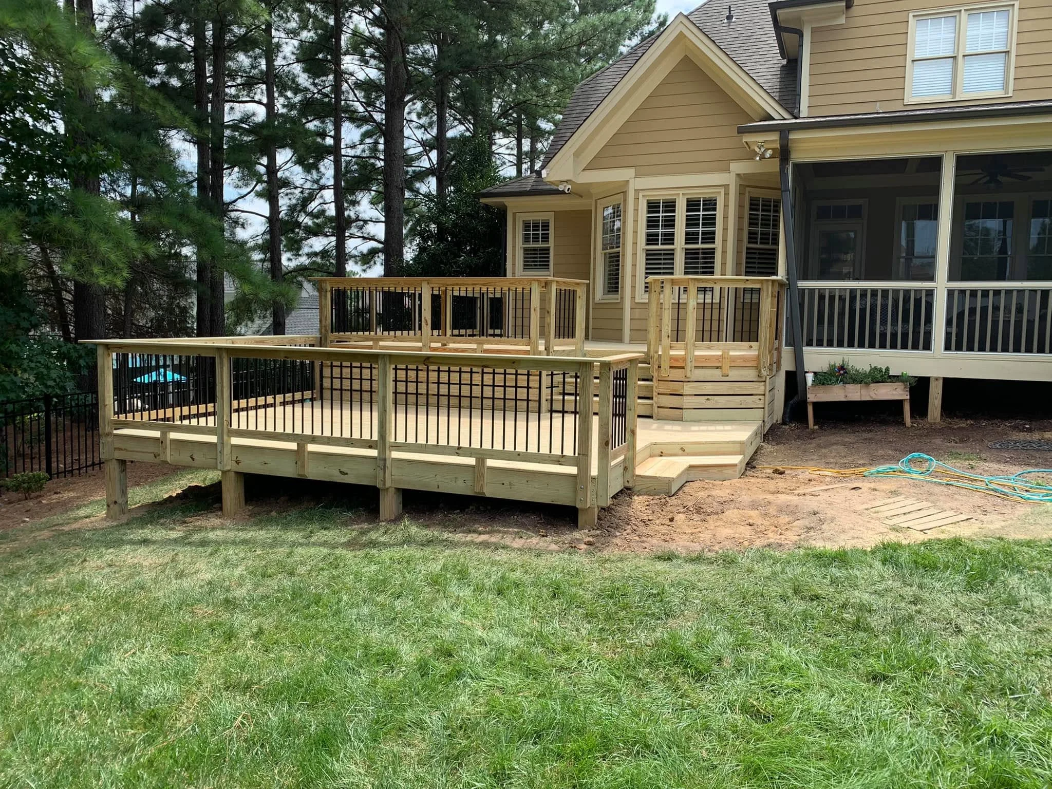Multi-level backyard wood deck with integrated pergola