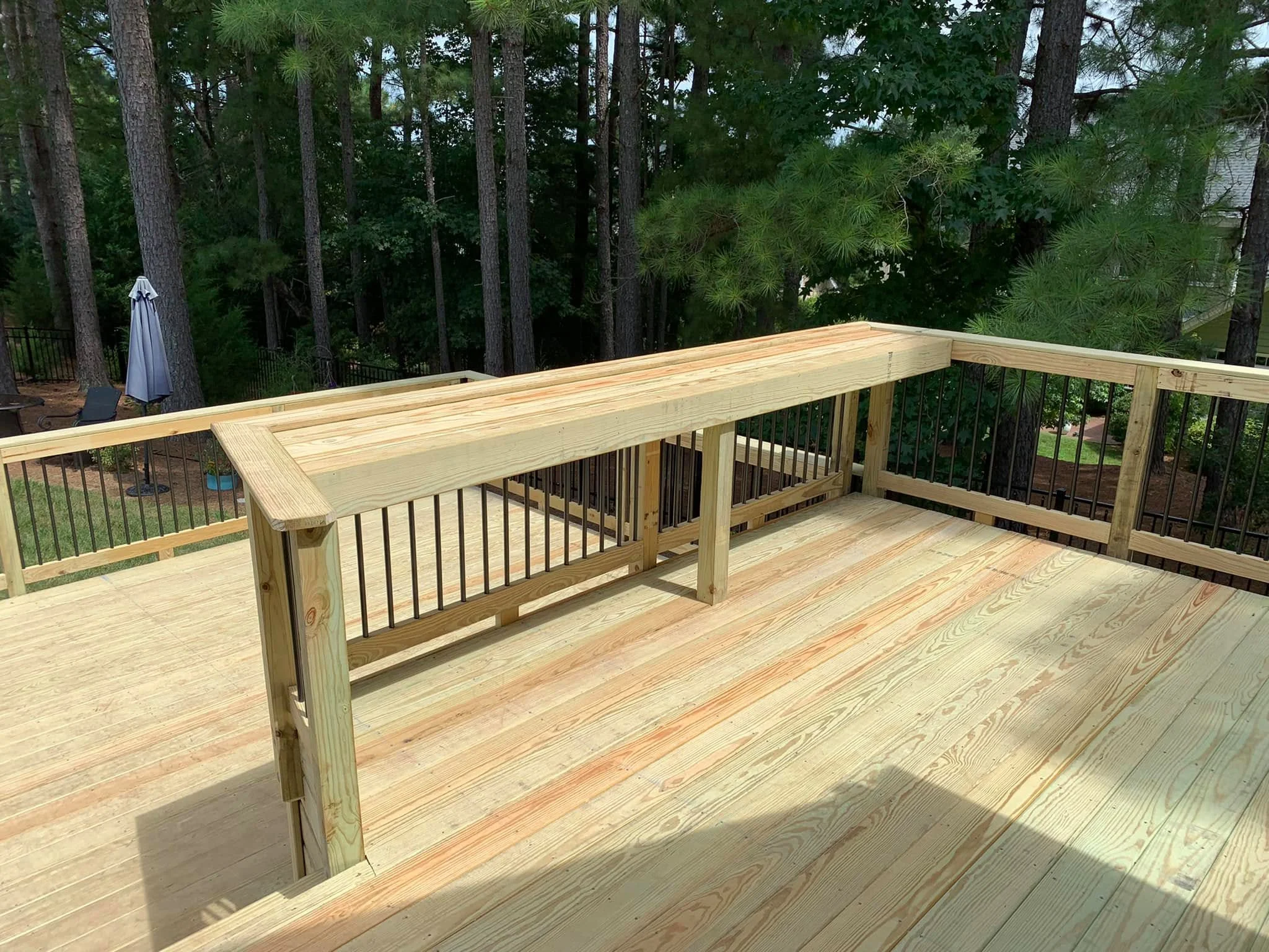 Custom wood deck with wide bar-top railing