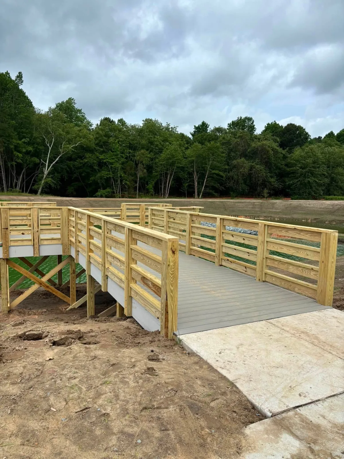Custom wooden walking bridge over pond