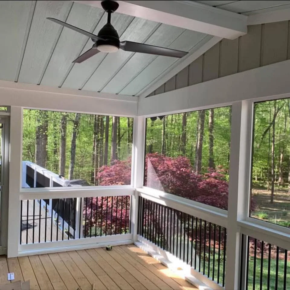 Screened porch interior with wood ceiling and fan
