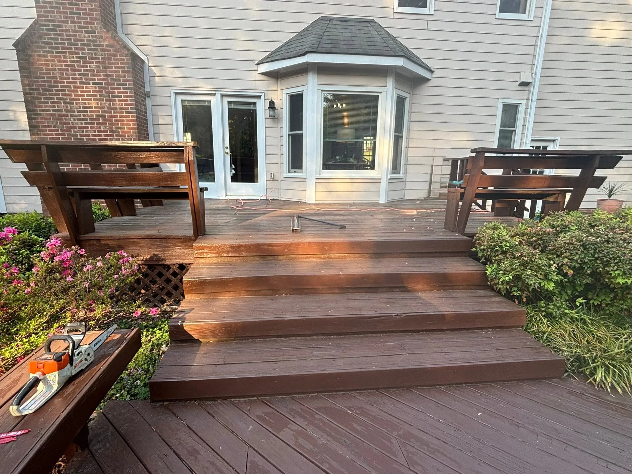 Stained backyard wood deck with wide steps